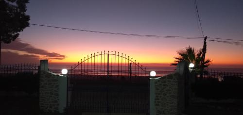 a roller coaster at sunset behind a fence at Kaouki beach Apart'hotel in Sidi Kaouki