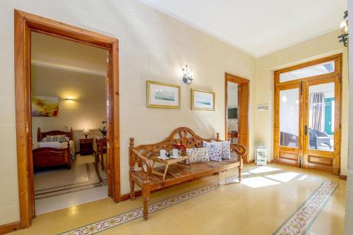 a living room with a couch and a mirror at Djar ta Menzja 2 Holiday Home in Sannat