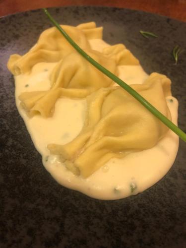 a bowl of cream with a green stick in it at Cavallino Lovely Hotel in Andalo