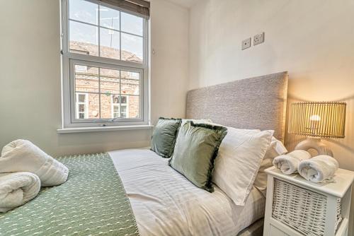 a bedroom with a bed and a window at Guest Homes - Bennett Apartment in Worcester