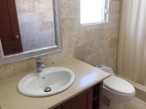 a bathroom with a sink and a toilet at Punta Rucia Cristal Beach in Punta Rucia