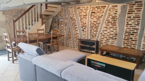 a living room with a couch and a wood stove at Votre maison en Touraine in Chissay-en-Touraine