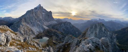 a view of a mountain range with the sun setting at Hotel Alla Posta - Famiglia Pra dal 1866 a Caprile in Alleghe