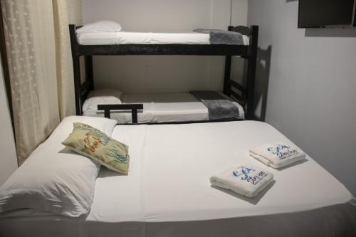 two beds in a room with three bunk beds at Sea Star Inn in San Andrés