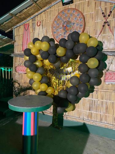a bunch of black and yellow balloons on a wall at Tridhara HomeStay in Guwahati