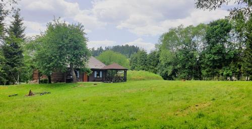 a house in the middle of a green field at Siedlisko Liskowate - Bieszczady in Ustrzyki Dolne