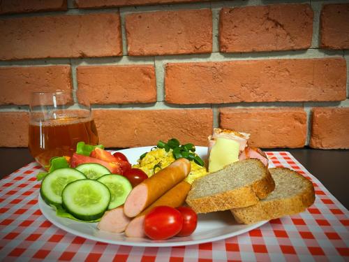 a plate of food with vegetables and bread on a table at M&W Hotel Wronowski in Łomża