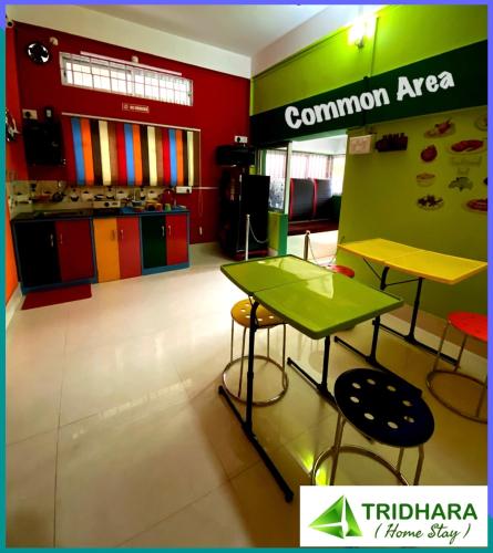 a store with a table and chairs in a room at Tridhara HomeStay in Guwahati