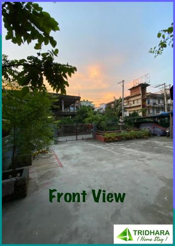 an empty parking lot with a sunset in the background at Tridhara HomeStay in Guwahati