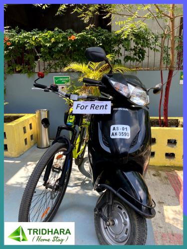 a scooter with a sign on it is parked at Tridhara HomeStay in Guwahati