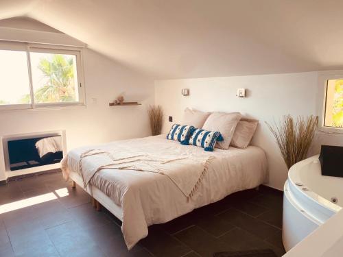 a bedroom with a bed and a tub and a fireplace at Villa Jungle Beach in Sainte-Maxime