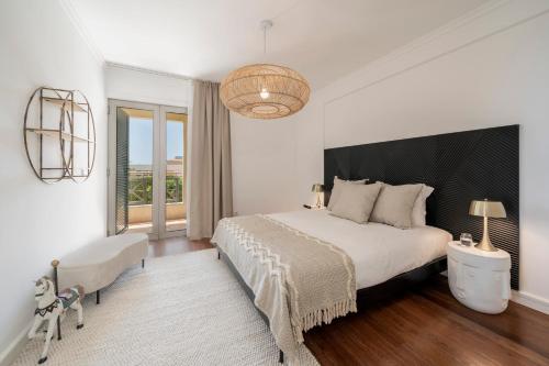 フンシャルにあるQuinta da Falésia II by An Island Apartの大きなベッドと大きな窓のある寝室