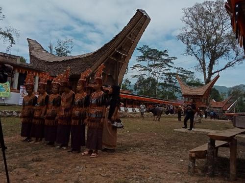 a group of people standing in front of a building at Toraja Bungin Homestay in Rantepao