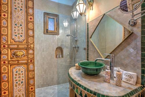 a bathroom with a sink and a shower at Riad Dar Fanny in Marrakesh
