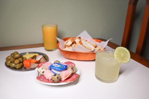 a table with plates of food and a glass of milk at Station Hotel (Adults Only) in Rio de Janeiro
