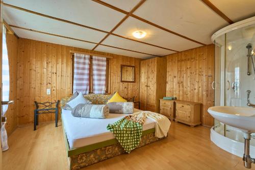 a bedroom with a bed and a sink at Neuhornbachhaus in Schoppernau