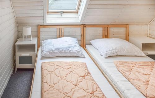 - 2 lits dans une petite chambre avec fenêtre dans l'établissement 2 Bedroom Lovely Home In Rewal, à Rewal