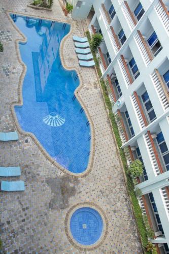 an overhead view of a swimming pool next to a building at Beach Studio @ Cowrie in Mombasa
