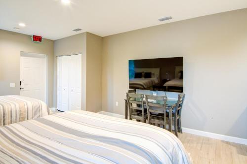 a bedroom with two beds and a glass table at HS#1- Modern Studio next to Premier Sports Complex in Bradenton