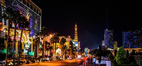 a city street at night with buildings and palm trees at Staybridge Suites Las Vegas - Stadium District in Las Vegas