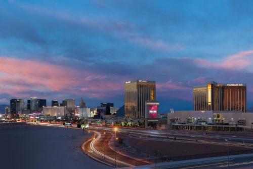 a city skyline at night with traffic on a freeway at Staybridge Suites Las Vegas - Stadium District in Las Vegas
