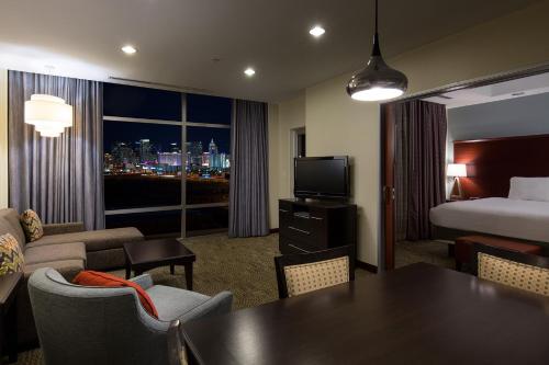 a hotel room with a bed and a table and a room at Staybridge Suites Las Vegas - Stadium District in Las Vegas