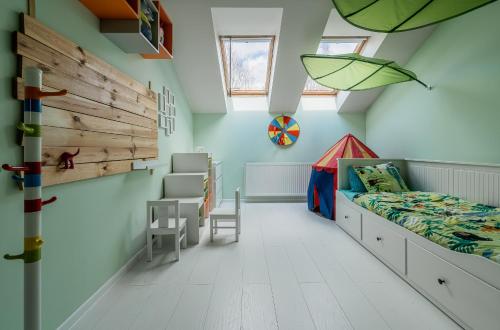 a bedroom with a bed and a desk and a chair at Grey House in Vilnius