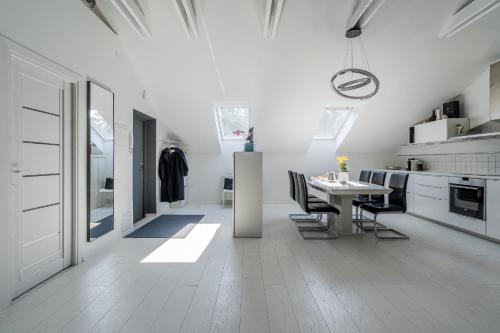 a kitchen and dining room with a table and chairs at Grey House in Vilnius