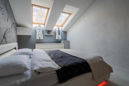 a bedroom with a bed with two pillows at Grey House in Vilnius