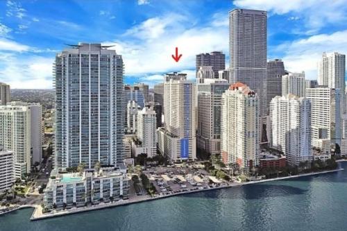a view of a city with a bird flying over the water at Lovely condo with city & ocean views. Sleep up to 6 people! in Miami