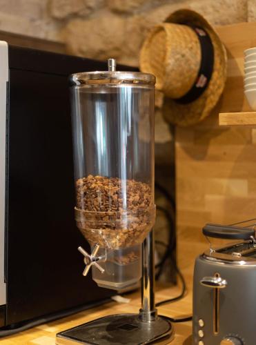 a glass jar filled with food sitting on a table at Hotel Mimosa Paris in Paris