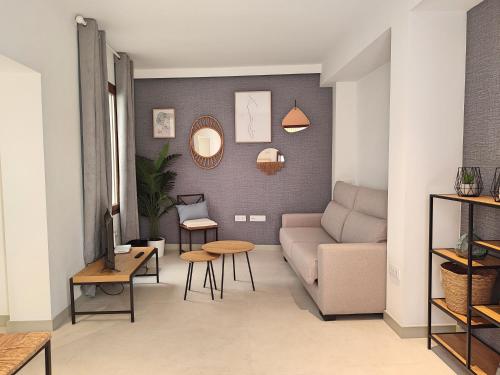 a living room with a couch and a table at Alojamiento San Basilio Suite in Córdoba
