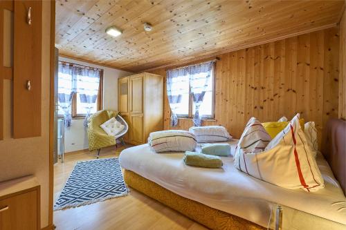a bedroom with a large bed in a room with wooden walls at Neuhornbachhaus in Schoppernau