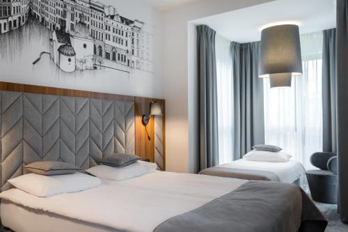 Postel nebo postele na pokoji v ubytování Focus Hotel Premium Kraków