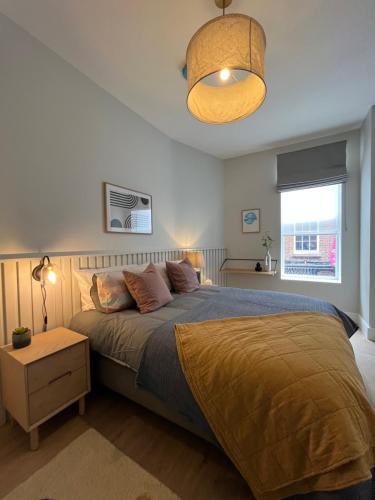 a bedroom with a large bed and a lamp at Sutcliffe House in Dublin