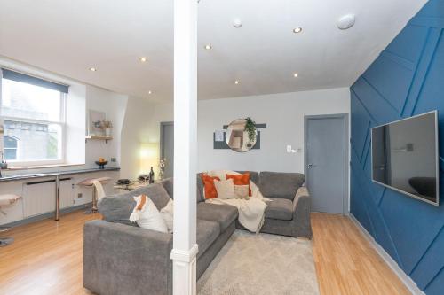 a living room with two couches and a tv at Vibrant City Centre Living in Aberdeen