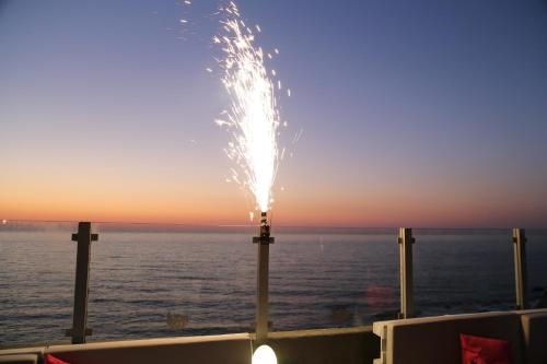 a fireworks display on a cruise ship in front of the ocean at Hotel Mar e Sol & Spa in São Pedro de Moel