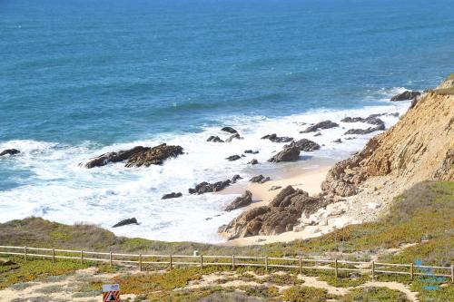 a view of a beach with rocks and the ocean at Hotel Mar e Sol & Spa in São Pedro de Moel