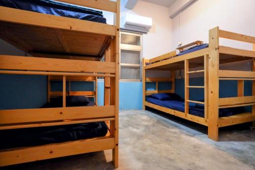 two sets of bunk beds in a room at Odyssey Divers Hostel in Xiaoliuqiu