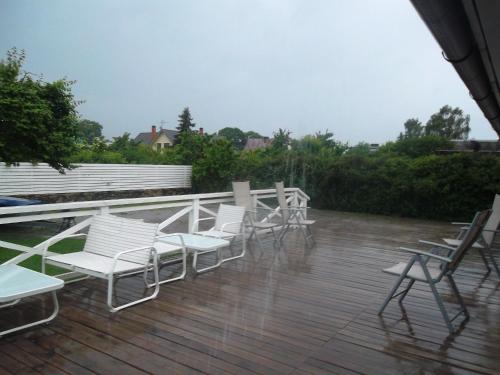 a group of chairs sitting on a deck in the rain at Ovelia B&B in Kuressaare