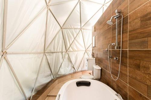 a bathroom with a shower and a toilet in it at Jângala Glamping Natureza in Juquitiba