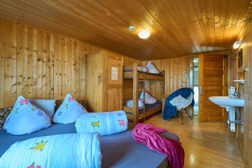 a bedroom with a bed and a sink in a room at Neuhornbachhaus in Schoppernau