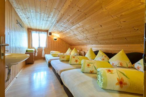 a room with a row of beds in a room at Neuhornbachhaus in Schoppernau