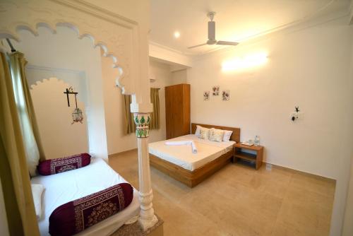 a bedroom with two beds and a ceiling at Royal Heritage Haveli Udaipur in Udaipur