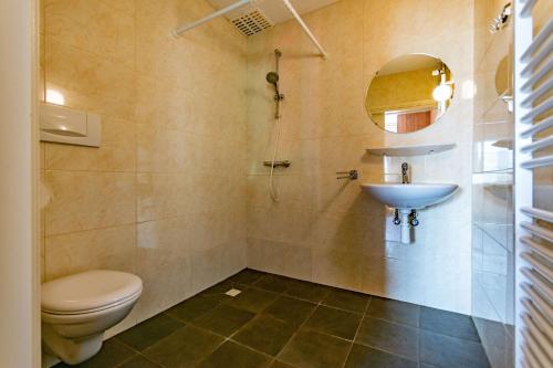 łazienka z toaletą i umywalką w obiekcie Terschelling Natuurlijk w mieście Kinnum