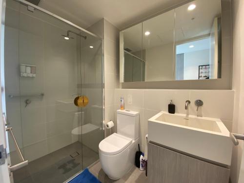 a bathroom with a toilet and a sink and a shower at Nintendo Theme-Adelaide CBD-King Bed-Gym-BBQ in Adelaide