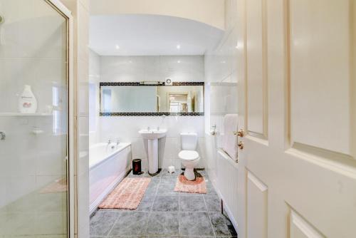 a white bathroom with a sink and a toilet at 2 Victoria Street in Armagh