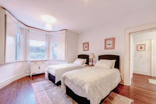 a bedroom with two beds and a window at 2 Victoria Street in Armagh