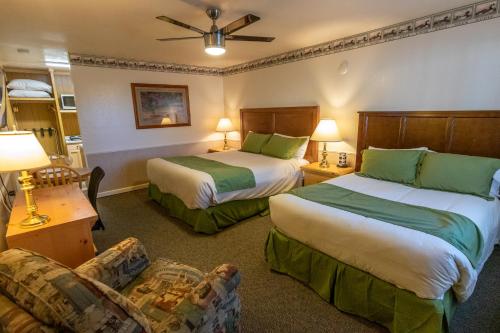 a hotel room with two beds and a couch at June Lake Motel in June Lake