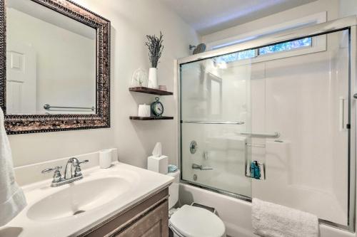 a bathroom with a sink and a shower and a toilet at Fayetteville Retreat with Hot Tub and Fenced Yard in Fayetteville